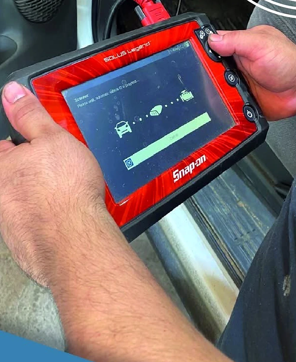 Close view of a diagnostic scan tool in use
